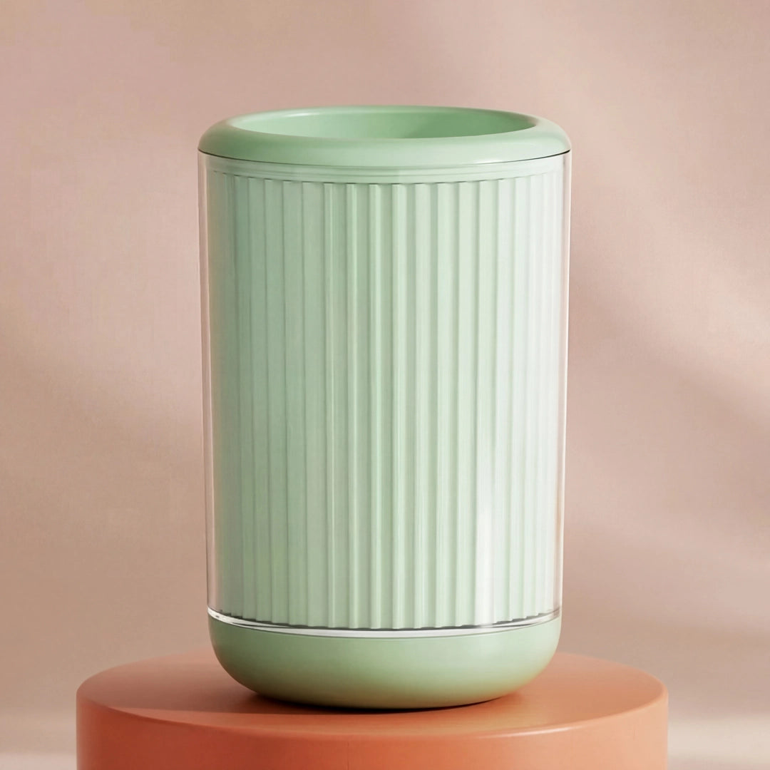 Light green cylindrical pet paw cleaner with ribbed texture on a peach-colored background