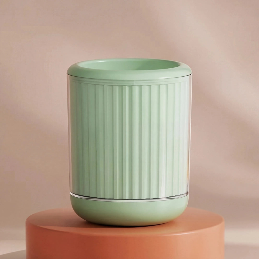 Green textured cylindrical pet paw cleaner on a peach-colored platform with a beige background
